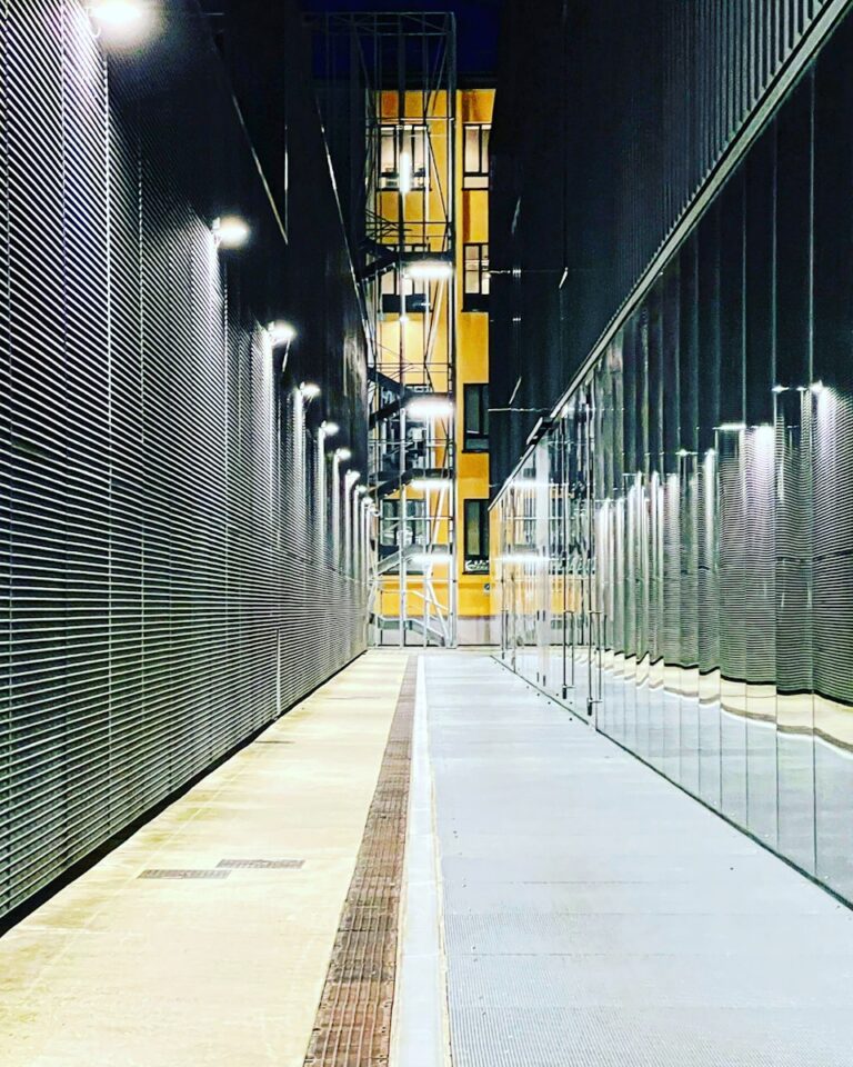 a long hallway with a clock on the side of it