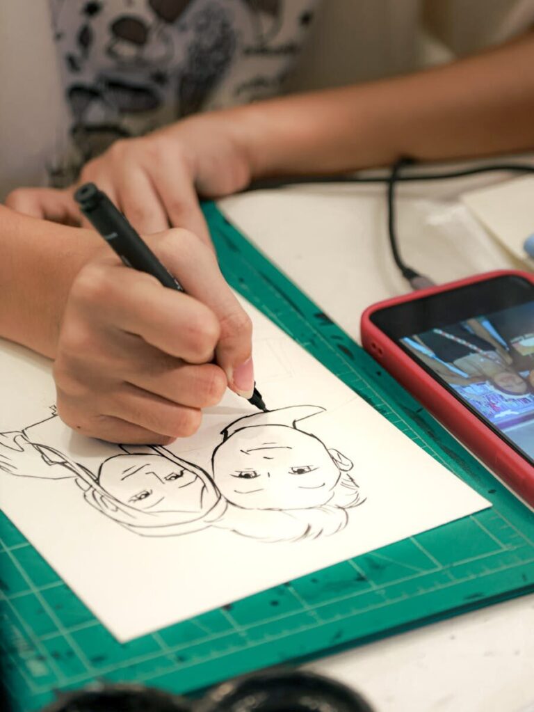 Close-up of a person illustrating with reference images on a phone in Bangkok.